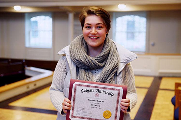 Providence Ryan ’16 on the stage of Memorial Chapel with the 1819 Award