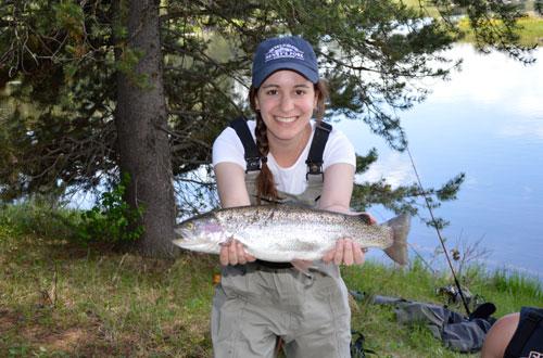 Arielle Sperling holds up a live fish