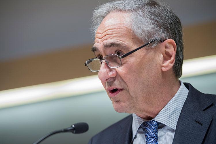 University of Chicago President Robert Zimmer speaks at podium in Love Auditorium